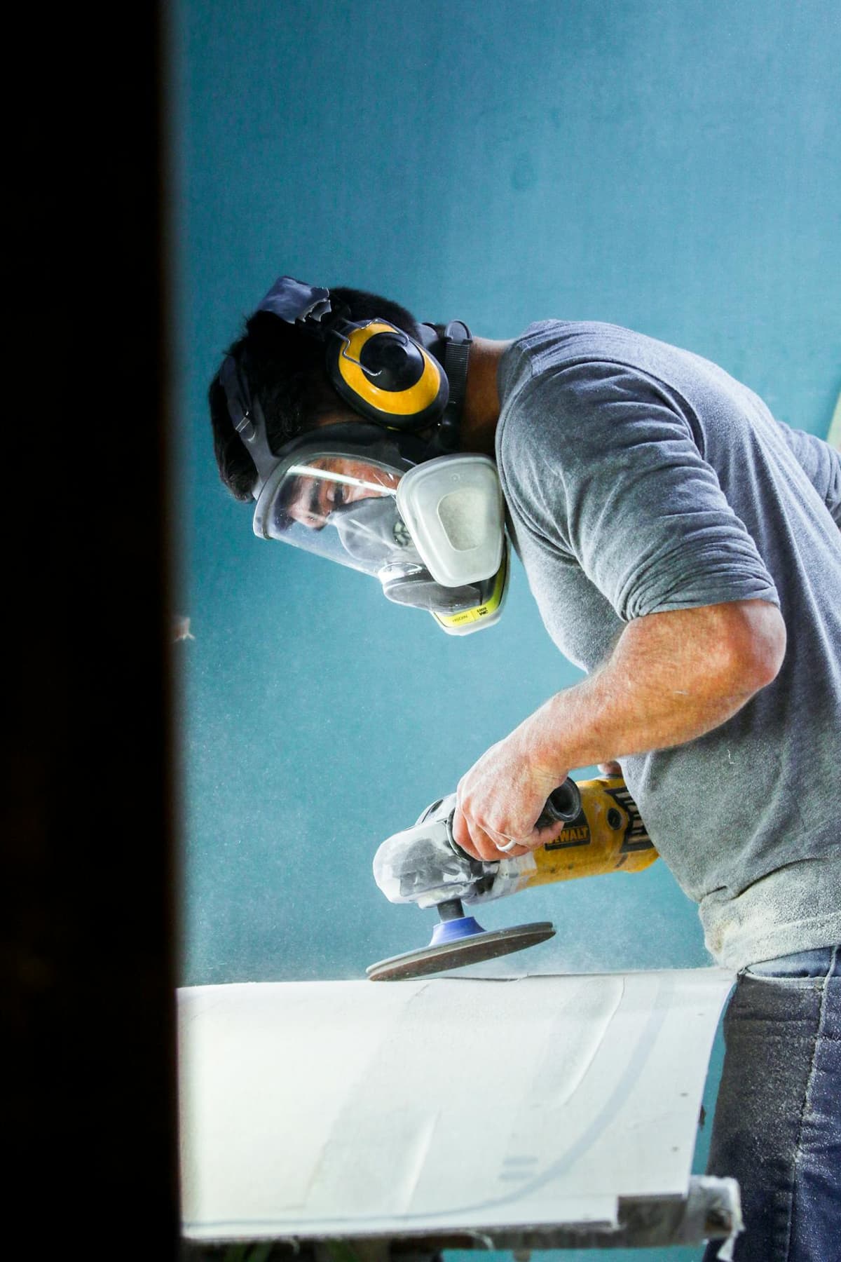 Tradie filling out a SWMS document on a tablet at a construction site